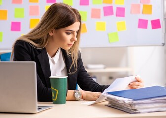 Young beautiful businesslady in conflicting priorities concept