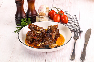 Prepared tasty beef ribs with sauce