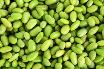 Raw green edamame soybeans as background, top view