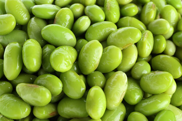 Raw green edamame soybeans as background, closeup