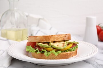 Tasty sandwich with grilled vegetables on white marble table, closeup