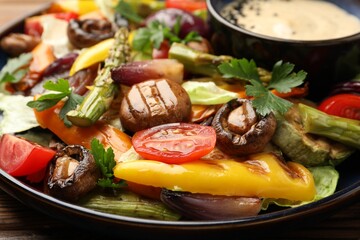 Delicious salad with grilled vegetables and sauce on table, closeup