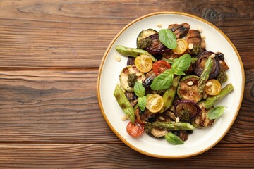 Delicious salad with grilled vegetables on wooden table, top view. Space for text