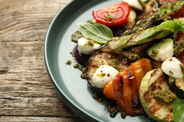 Delicious salad with grilled vegetables on wooden table, closeup