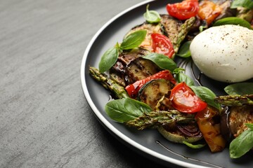 Tasty salad with grilled vegetables and mozzarella cheese on grey table, closeup
