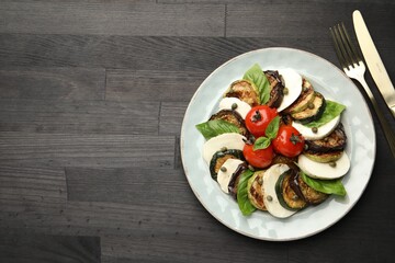 Tasty salad with grilled vegetables and mozzarella cheese served on wooden table, flat lay. Space for text