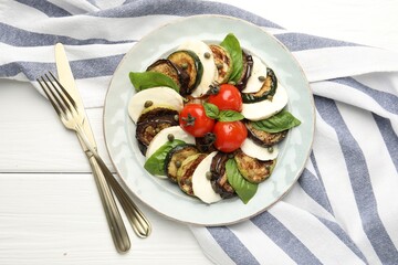Tasty salad with grilled vegetables and mozzarella cheese served on white wooden table, flat lay