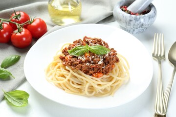 Delicious pasta bolognese served on white table