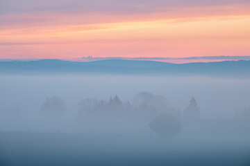 Beautiful nature landscape, amazing view of autumn meadow. Sun beams through fogg. Magic colours of Summer. Breathtaking wallpaper.
Serene land in the Countryside with solitery trees. Misty morning
