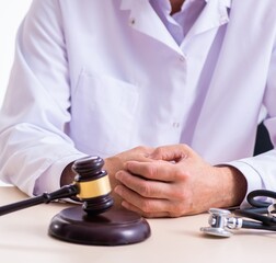 Male doctor in courthouse meeting with lawyer