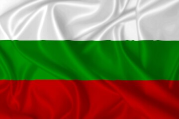 Flag of Bulgaria waving in the wind on silk texture