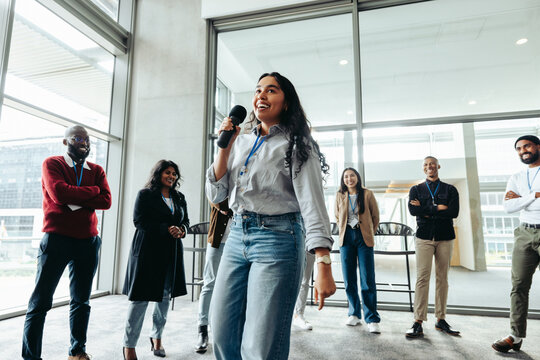 Young corporate employees at team building event with speaker