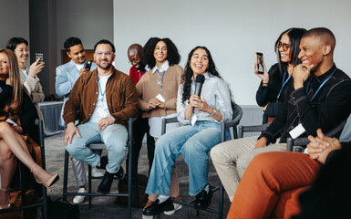 Engaged young entrepreneurs sharing success stories and ideas during a lively group discussion...