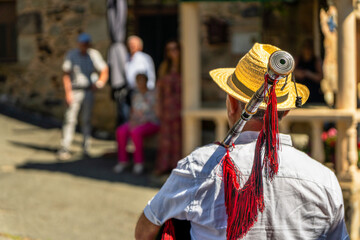 Middle-aged man with his back turned, piper of a traditional piper band playing traditional...