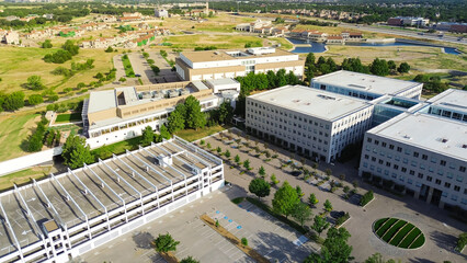 Office campus buildings with multi-level garages rooftop parking lots incorporate shade structure...