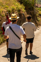 Traditional band of bagpipers with tambourines and bass drums playing traditional Galician music through the streets of a Galician village for the town's traditional festivals.