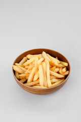 french fries in a wooden bowl.