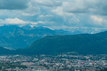 Panoramic aerial view of the city of Villach surrounded by majestic mountain ranges of Julian Alps and Karawanks, Carinthia, Austria, Europe. Idyllic forest walk near the Landskron Castle. Cityscape.