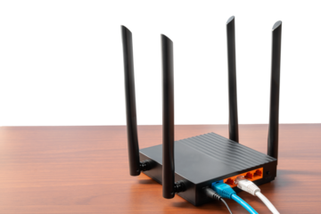 Modern wireless wi-fi router at wooden table indoors on isolated white, with copy space. Wireless connection concept, close up