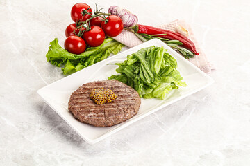 Frilled beef burger cutlet with iceberg