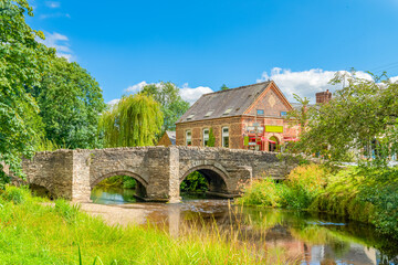 The Old Bridge, a stone bridge crossing the River Clun, in the beautiful village of Clun in Shropshire, UK.