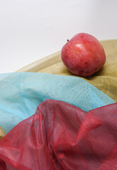 Reusable polyester fabric mesh bags for fruits and vegetables. Breathable and quick-drying material. Three colors blue, red, and khaki.  Shallow depth of field. Copy space.