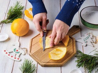 Step by step preparation of candied orange peels on light wooden background. Merry Christmas...