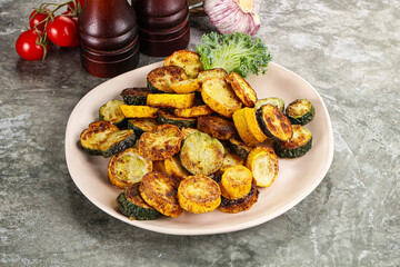 Roasted young zucchini in the plate