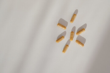Dietary supplements on white background.  Vitamins and trace elements in capsules. Proper use of...