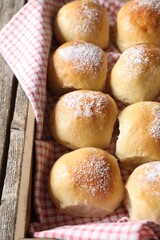 Delicious dough balls on wooden table, closeup