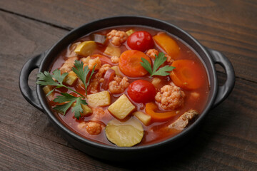 Tasty homemade stew with vegetables on wooden table, closeup