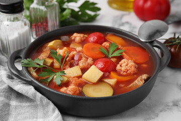 Tasty homemade stew with vegetables on white marble table, closeup