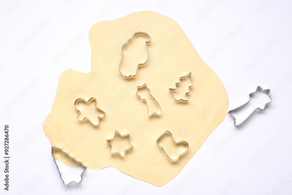 Wall mural raw dough and cookie cutters isolated on white, top view