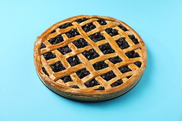 Tasty homemade pie with blueberries on light blue table