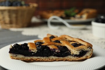 Piece of tasty homemade pie with blueberries on table, closeup