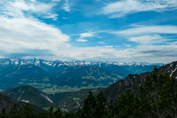 Scenic aerial view of majestic alpine landscape with snow-capped mountain ridges of Schladminger Tauern in Ramsau am Dachstein, Styria, Austria. Hiking trail through alpine greenery in Austrian Alps