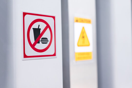 No food and beverages allowed in this area sign on white wall background