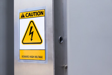 Caution sign: Beware of high voltage on the wall of the building, safety concept