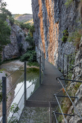 Iron walkways anchored to the side of the rock mountain and with river on the side
