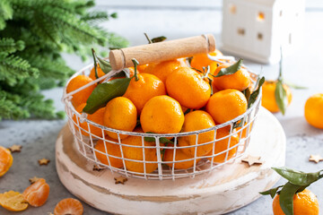 Tangerines in a basket in Christmas decor, selective focus