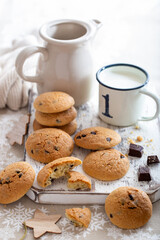 Cookies with chocolate and a glass of milk for the Christmas table, selective focus