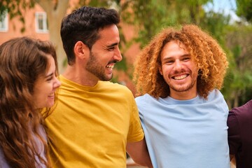 Fototapeta premium Group of young friends having fun, laughing and hanging out together at street.