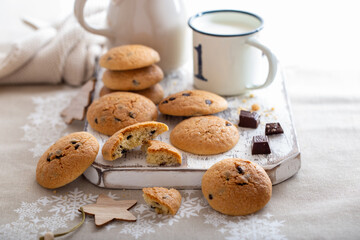 Cookies with chocolate and a glass of milk for the Christmas table, selective focus