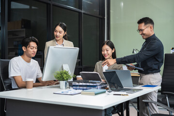Business team working on a project in the office or reviewing and discussing a business project.