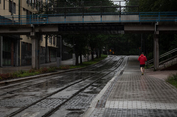 Person running outdoors in the city. People active outdoors. Outdoor run. Healthy lifestyle.