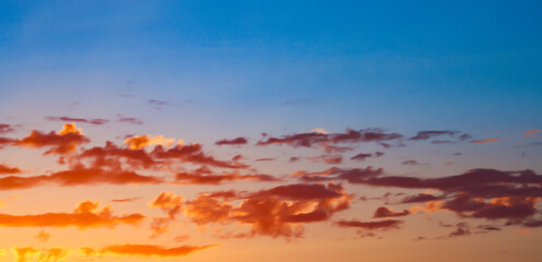 Panorama of sunset orange clouds and clear blue sky with copy spacew