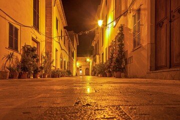 Image of a deserted street in a historic Spanish village in artificial light