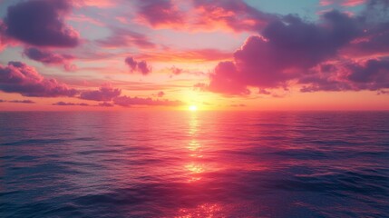 Obraz premium Pink sunset over a calm ocean with a bright sun reflecting on the water.