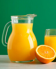 Tasty orange juice and fresh fruit on white wooden table