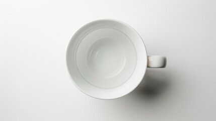 Empty white coffee mug on a blank background, waiting to be filled